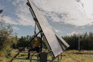 A woman adjusts residential solar panels.