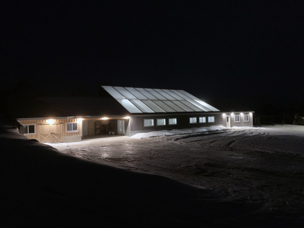 Woodleigh Farms passive solar greenhouse at night